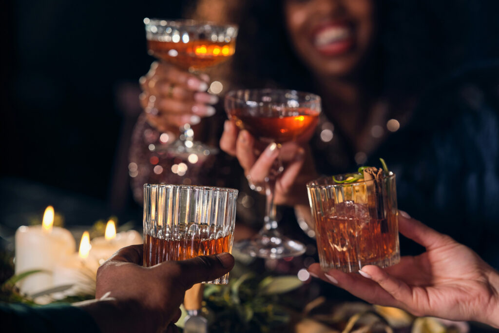 group of people, dinner party, holiday, raising glasses, cocktails, old fashioned cocktails